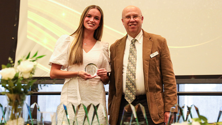 From left, Lauren Mortimer, a senior dual dance and early childhood education major from Butler (Butler HS), is awarded the College of Liberal Arts’ Outstanding Student in Research, Scholarship or Creative Activity award from Dean Dan Bauer.