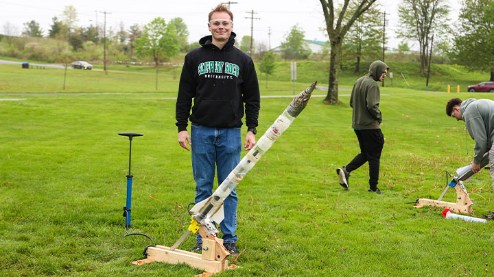 Jacob Cerra, a junior mechanical engineering major, displays his water rocket during a launch demonstration on campus as part of a Thermal System Design class at SRU.
