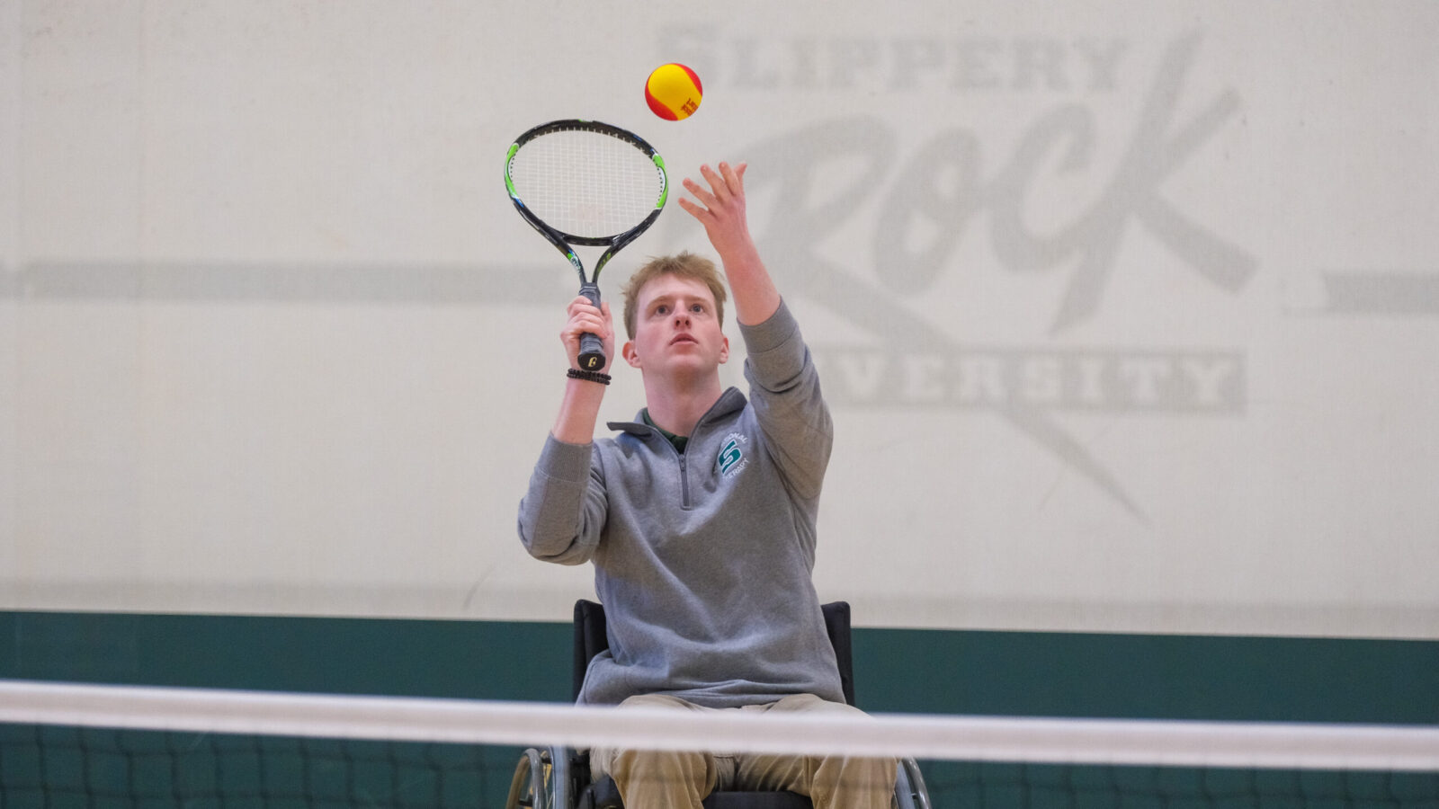 Josh Burlingham lines up a serve during a game of wheelchair tennis
