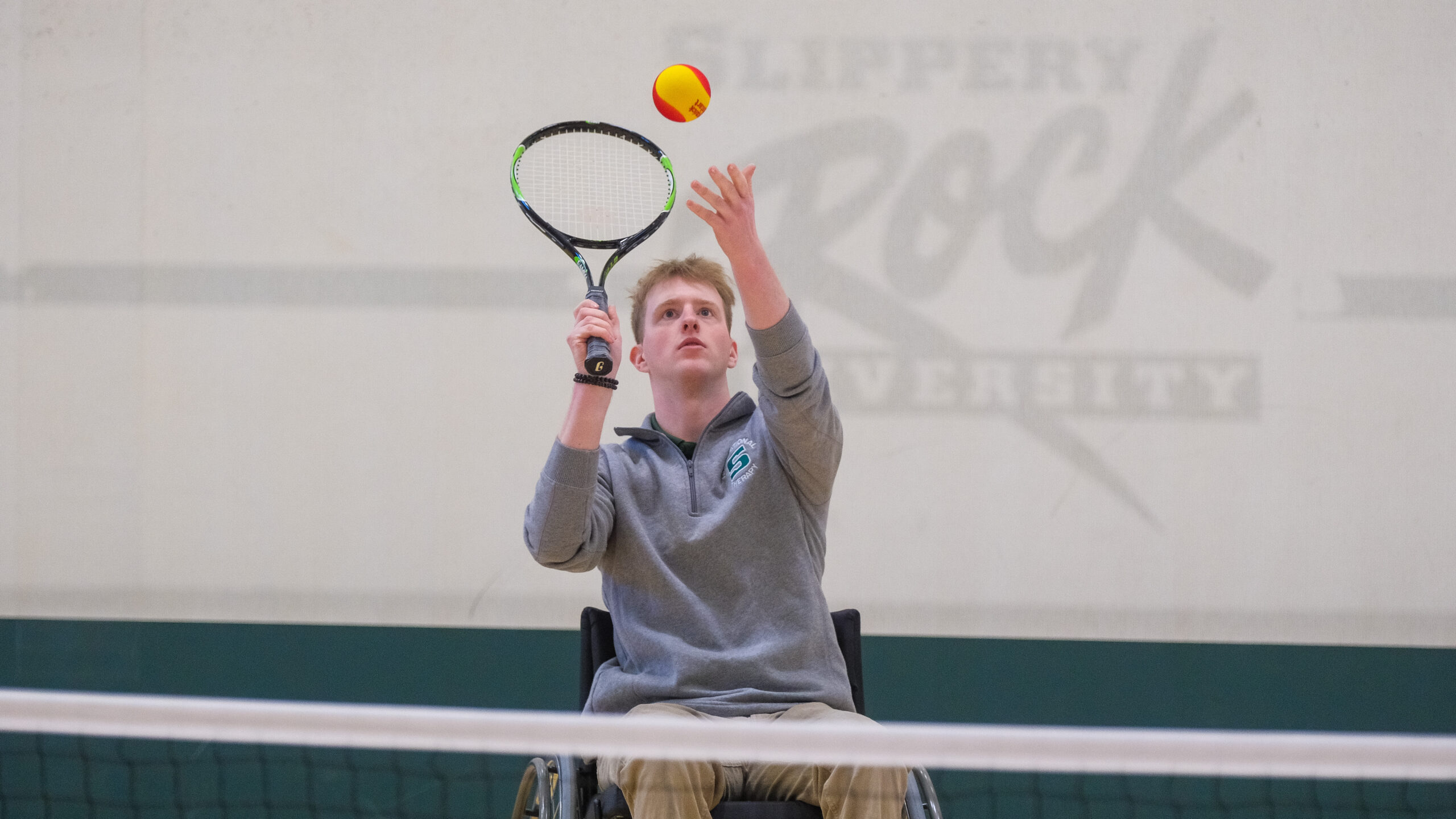 Josh Burlingham lines up a serve during a game of wheelchair tennis