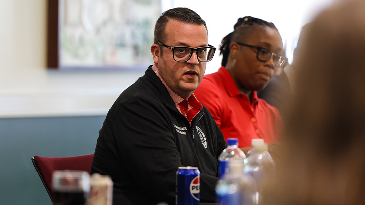 Joshua Young speaking at trustees meeting.