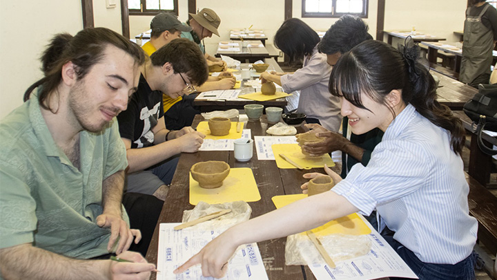 From left, Slippery Rock University student Michael Leitera works with Saga University student Manari Suzuyama during a porcelain making worship in Arita, Japan.