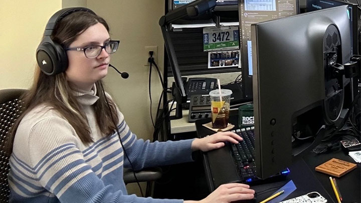Woman at computer with headset