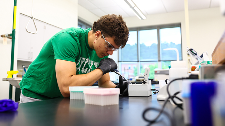 Cooper Alleman, an SRU junior chemistry major, prepares samples to test in the lab at the Advanced Technology and Science Hall as part of a faculty-student research project analyzing alpha-synuclein, a protein found in the human body primarily within brain neurons.