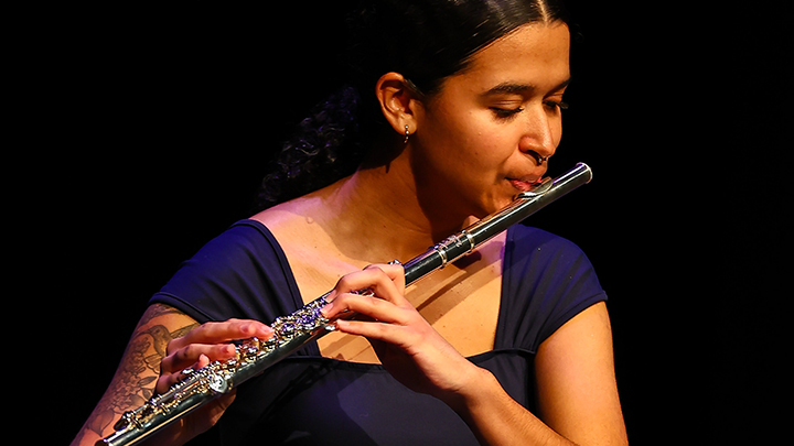 Woman playing flute.