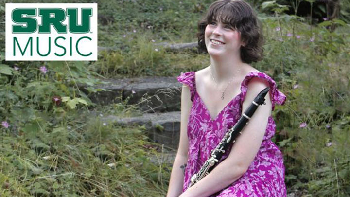 Student sitting with clarinet.